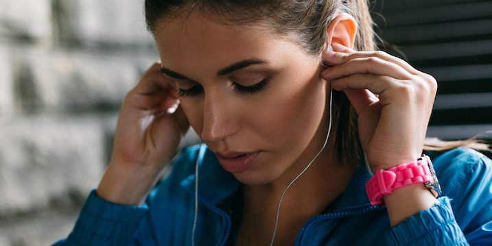 woman-putting-in-headphones-workout