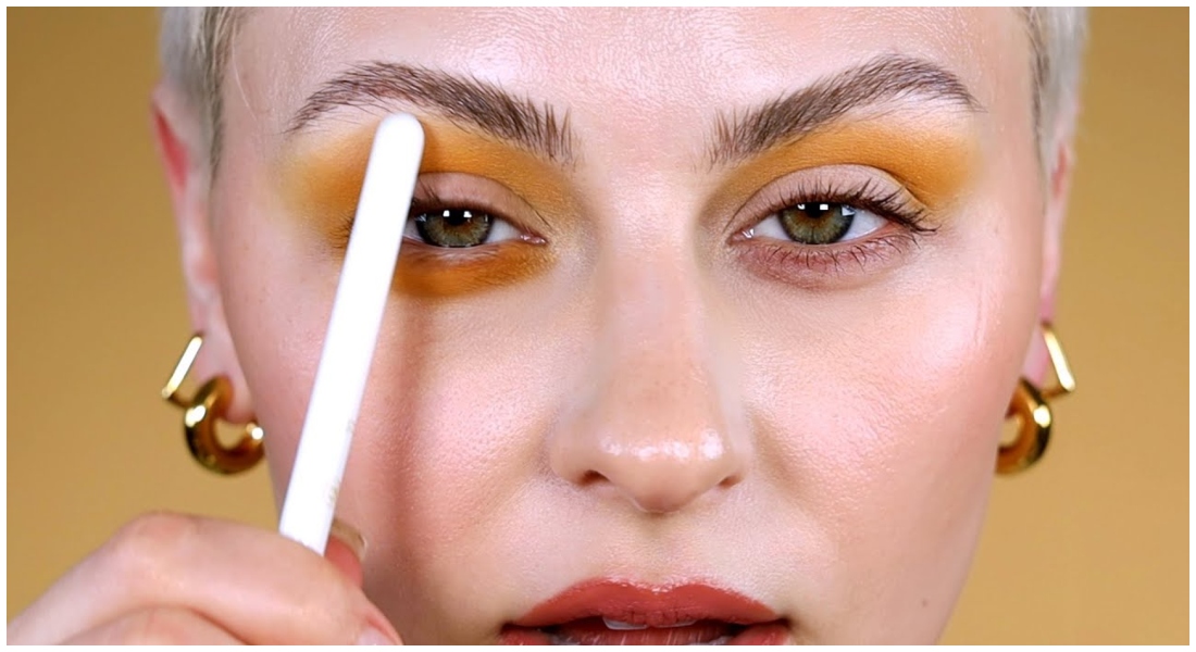 Žena so žltým očným make-upom