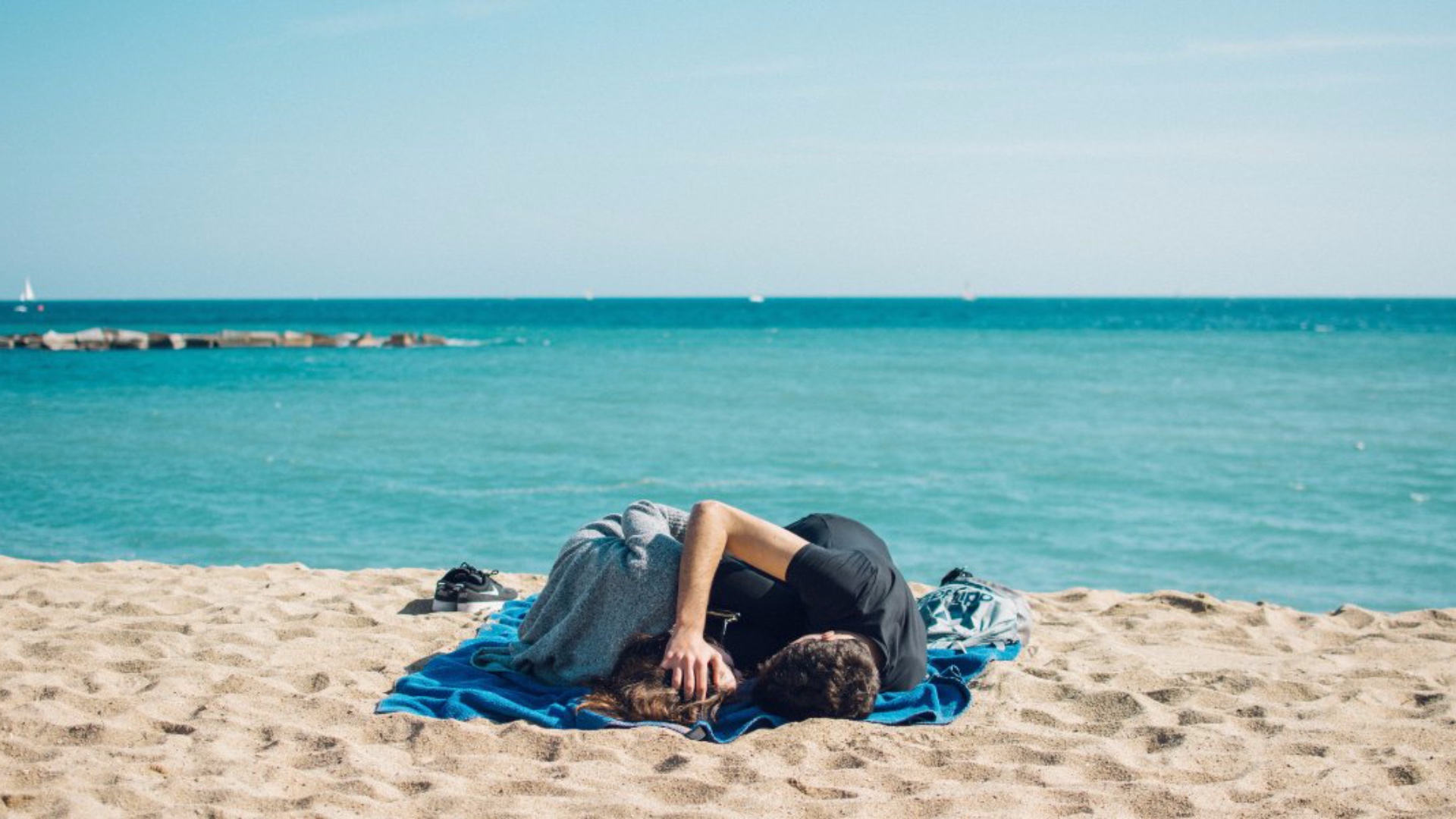 Dvojica leží na pláži