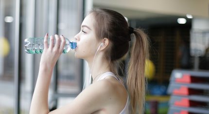 Mladá žena pije vodu